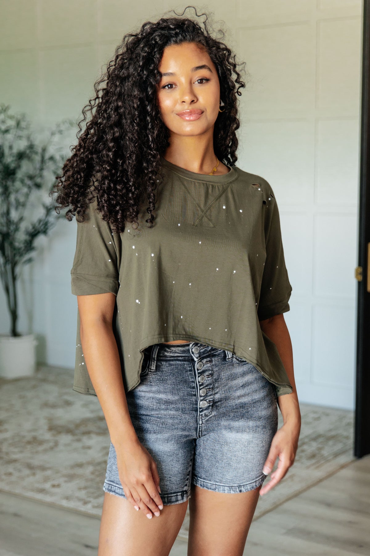 Less Than Stressed Asymmetrical Distressed Top - 5/22/2025