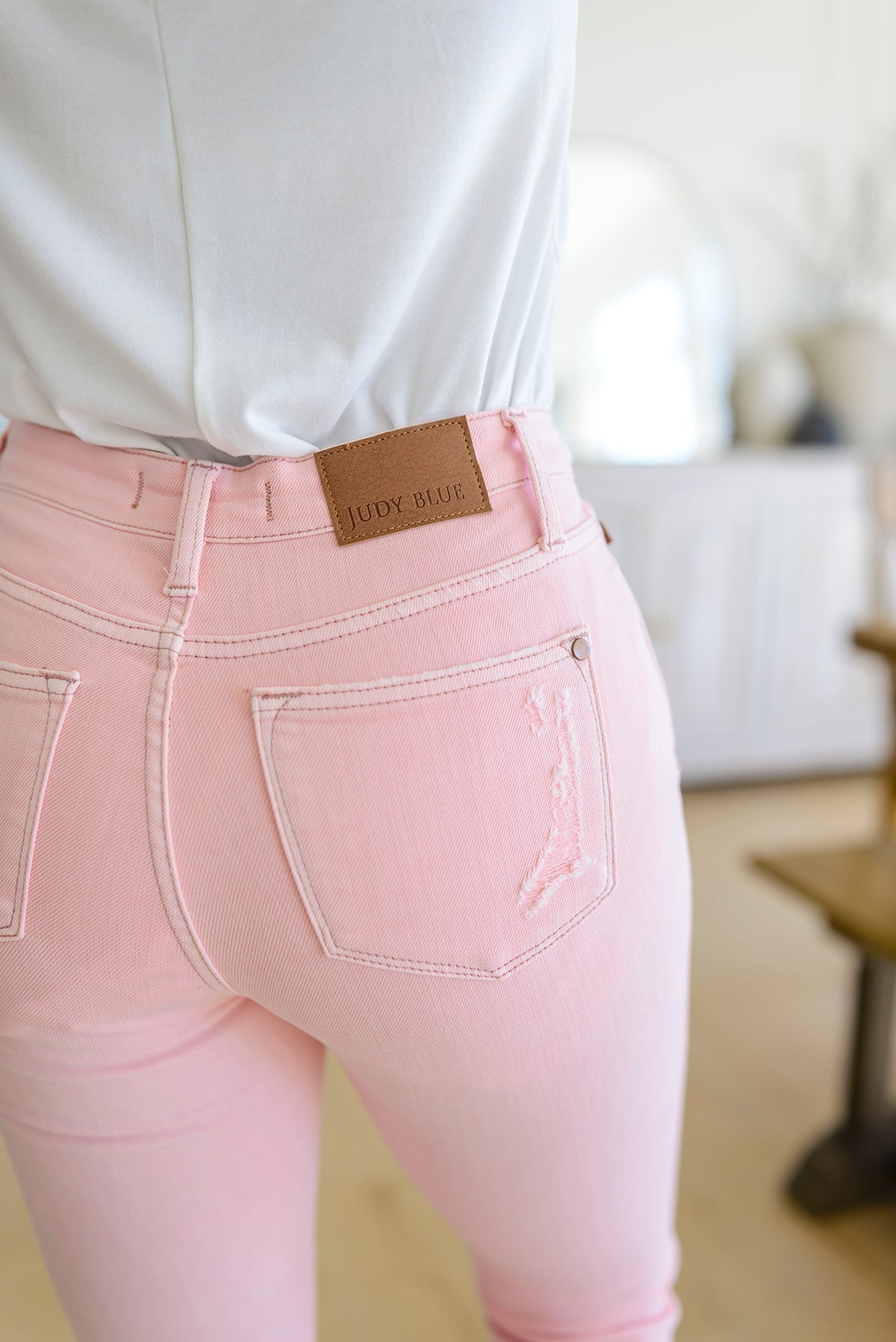 Feminine Flair Mid Rise Distressed Flares in Pastel Pink - 3/7/2023